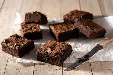 Homemade pieces of brownies on wooden table	