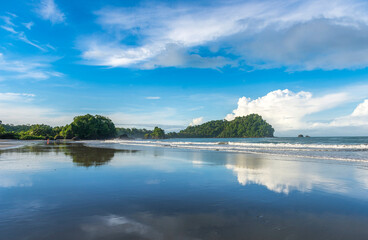 Manuel Antonio beatiful tropical beach with white sand, green palms and blue ocean. Paradise. National Park in Costa Rica, Central America.