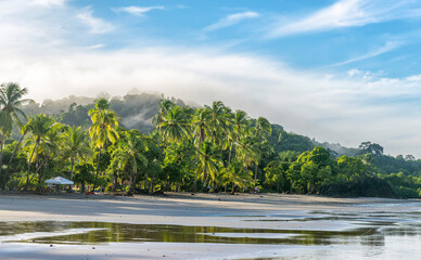 Manuel Antonio beatiful tropical beach with white sand, green palms and blue ocean. Paradise....