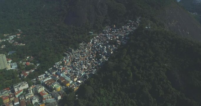Rio de Janeiro high aerial above a favela nested in the tropical mountain forest