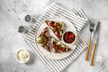 Bruschetta with cream cheese and sun-dried tomatoes. Sandwich or crostini made from wholegrain...