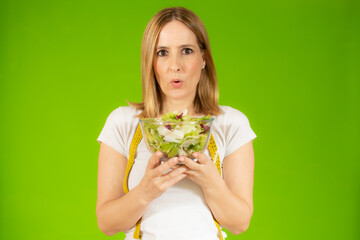 Woman diet concept portrait. Young woman hold green salad. Isolated portrait.