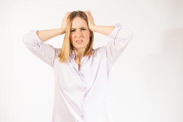 Portrait of young woman wearing casual clothes touching her head and expressing worry isolated over white background