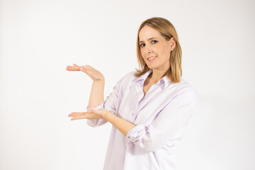Fototapeta premium Beautiful young woman holding something over white background