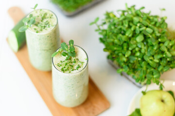 smoothie of micro-green apples cucumber and spinach on a light background. eco organic fresh food detox . ingredients fresh micro-greens . close-up selective focus