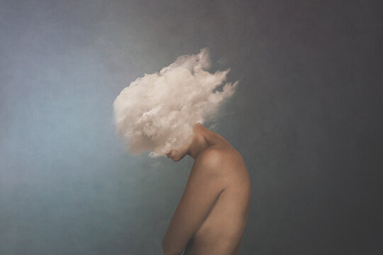 surreal image of a white cloud covering a woman's face, concept of freedom