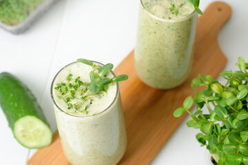 smoothie of micro-green apples cucumber and spinach on a light background. eco organic fresh food detox . ingredients fresh micro-greens . close-up selective focus