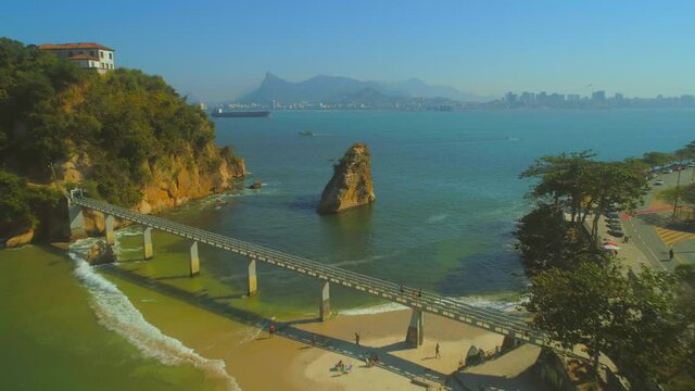 Aerial heading towards natural rock and Boa Viagem Bridge and Island in the Guanabara Bay