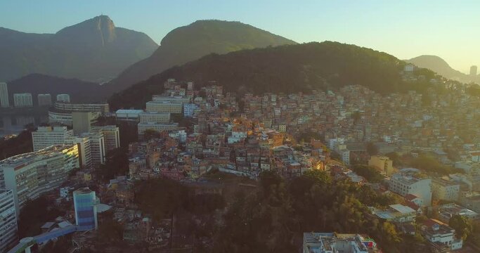 Aerial tracking past hilltop favelas and luxury high rise apartment buildings in Rio de Janeiro Brazil