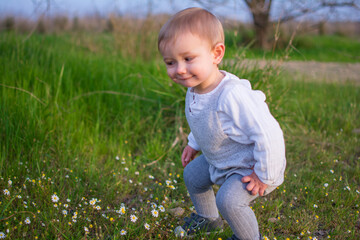 Baby  Playing In A Field Of Spring Flowers. Spring Concept