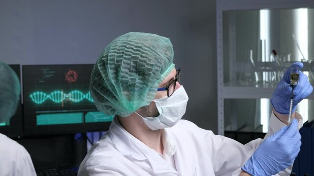 Scientists are researching for Covid19 vaccine in a laboratory. Doctors are testing  a new phamaceutical.