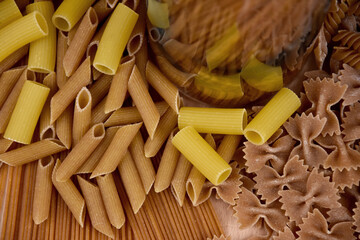 Different types of dried pasta top view stock images. Group of dried uncooked wholemeal pasta stock images. Mixed uncooked italian pasta close-up photo