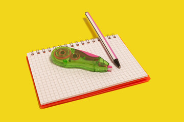 tape corrector and pen on a copybook