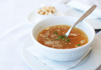 traditional chicken soup served in a bowl over white background