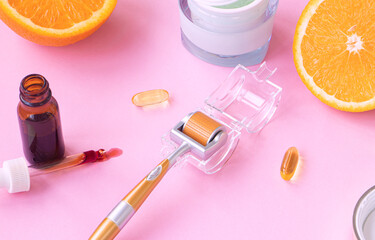 cosmetic instrument for microdermabrasion. background of open face serum spilled from a pipette. Face cream and citruses in the background. Vitamin C concept in skin care, cosmetics and cosmetology.