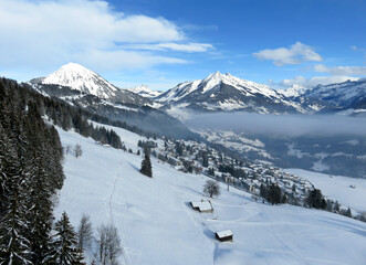 Fototapeta na wymiar Aerial view of snowy alpine landscape in Leysin, Switzerland