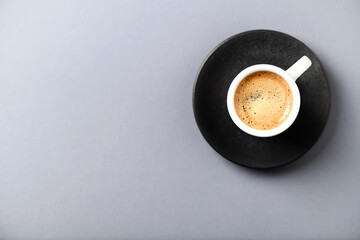 Cup of coffee on gray background. Top view.	