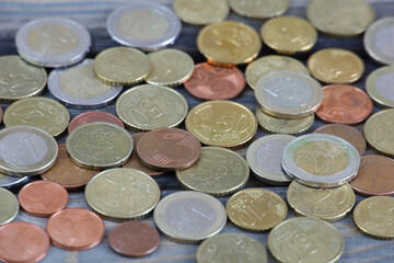 Coins of different denominations on the table. Euro and cents. Money, budget, income, expenses, finance, and economics. 