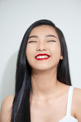 Naklejka premium Young woman Asian appearance with black hair stands isolated white background in Studio.