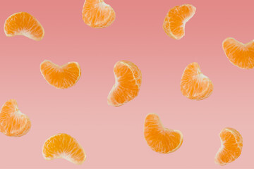 Peeled clementine slices pattern on pastel pink background. Minimal fruit concept.