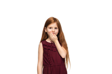 Shy, cute. Happy, smiley little caucasian girl isolated on white studio background with copyspace for ad. Looks happy, cheerful. Childhood, education, human emotions, facial expression concept.