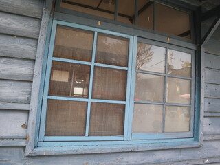 blue wooden window of aged wooden house design for retro and vintage concept