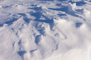 Fototapeta na wymiar Snowy ground with blue shadows. Close-up. Arctic winter background
