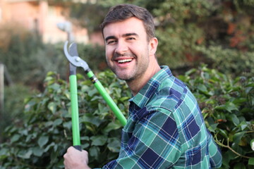 Fototapeta premium Young man using garden scissors 