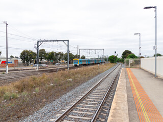 Commuter train approaching a train station in Melbourne Victoria Australia