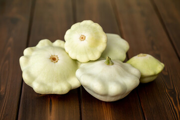 Zucchini, squash on a wooden table in a wicker basket. Vegetable harvest season. Vegetarian healthy food.