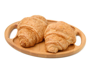 two baked croissants lie on a wooden tray, food isolated on white background, top view