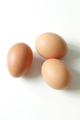 minimalism food photography, raw fresh brown egg on white background