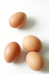 minimalism food photography, raw fresh brown egg on white background