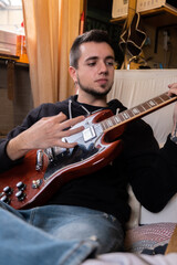 Man playing the guitar at the studio