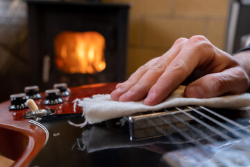 musician cleaning the guitar