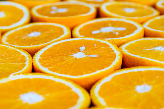 Lots of citrus fruits cut in half to make juice