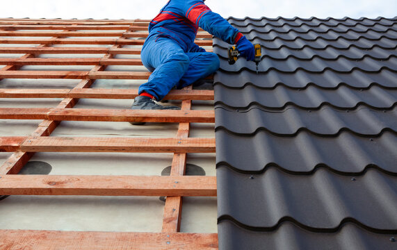 Man Worker Uses A Power Drill