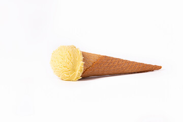 Appetizing vanilla ice cream cone lying down