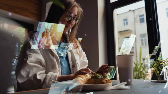 Hologram floating photos. Caucasian woman using a smartphone in cafe. Concept of Social networking service. Communication network. Hologram floating photos.