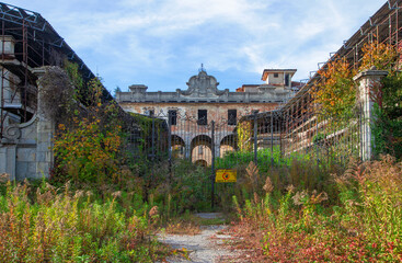lost old factory, an old abandoned building overgrown with weeds
