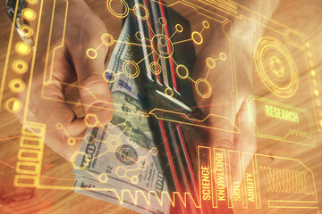 Double exposure of technology drawing hologram and us dollars bills and man hands. Data concept