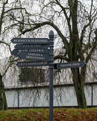 Multiple direction signs placed in the public park Stadsparken in Lund Sweden