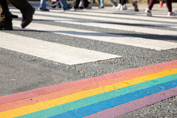 Rainbow flag, gay pride flag or LGBTQ pride flag painted on asphalt. City crosswalk decoration - obrazy, fototapety, plakaty