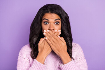 Photo of shocked guilty dark skin lady dressed knitted pullover arms cover mouth isolated purple...