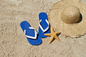 Fototapeta na wymiar Straw hats and accessories on the beach sand