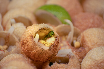 Indian pani puri served with potato, pickles and chutneys