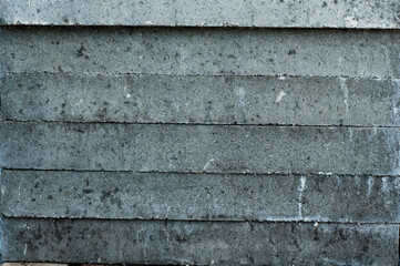 Gray concrete wall, old surface with peeling plaster. Building board texture