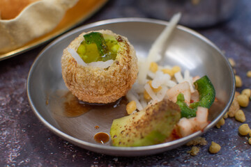 Indian pani puri served with potato, pickles and chutneys