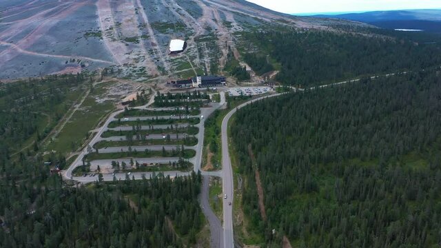 Aerial view of the Y1 Ski shop and restaurant area, under the bike trail slopes of Yllastunturi fell, in Yllas, Lapland - reverse, tilt up drone shot