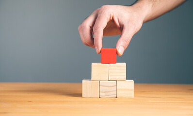 business man holding wooden cubes.